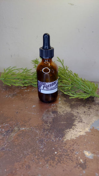 Poison labeled amber apothecary, glass dropper bottle. Halloween Medical decor.