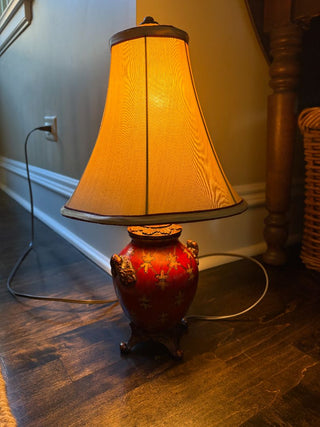 Decorative lamp with a textured shade on a wooden floor.