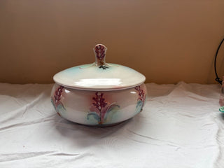 pink and green round ceramic dish with lid