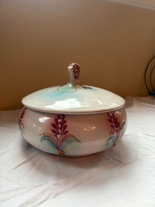 pink and green round ceramic dish with lid