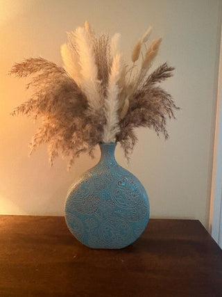 teal ceramic vase with feather flowers