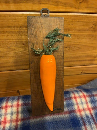 Ceramic carrot on wood
