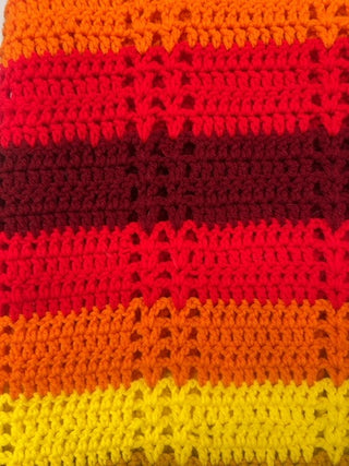 Vintage, handmade afghan blanket in retro colors.