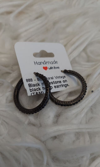 Black rhinestone on black hoop earrings. (T&M) -