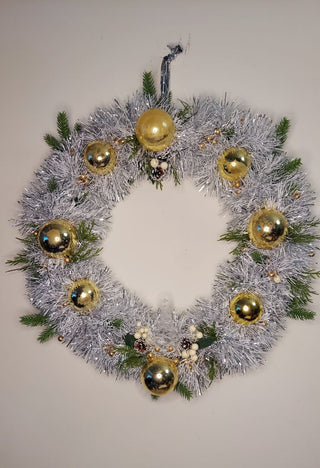 Midcentury mercury glass gold ornaments with mistletoe and pine on silver and white tinsel wreath