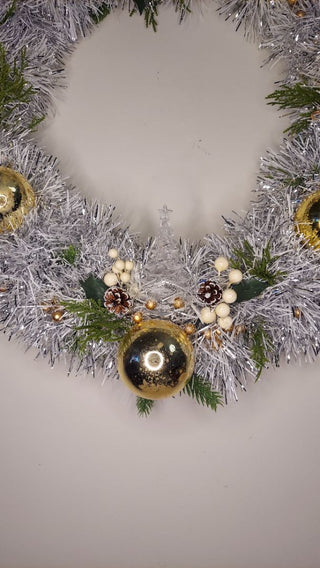 Midcentury mercury glass gold ornaments with mistletoe and pine on silver and white tinsel wreath