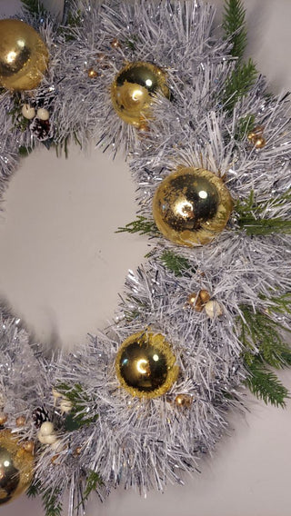 Midcentury mercury glass gold ornaments with mistletoe and pine on silver and white tinsel wreath