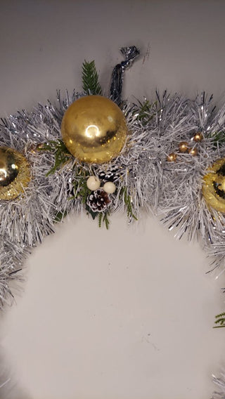 Midcentury mercury glass gold ornaments with mistletoe and pine on silver and white tinsel wreath