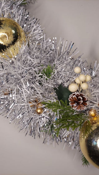 Midcentury mercury glass gold ornaments with mistletoe and pine on silver and white tinsel wreath