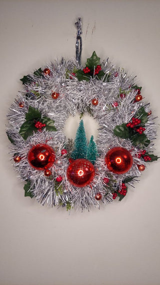 Midcentury mercury glass red ornaments with mistletoe Holly Berry and bottle brush trees on silver and white tinsel wreath