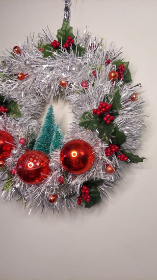 Midcentury mercury glass red ornaments with mistletoe Holly Berry and bottle brush trees on silver and white tinsel wreath