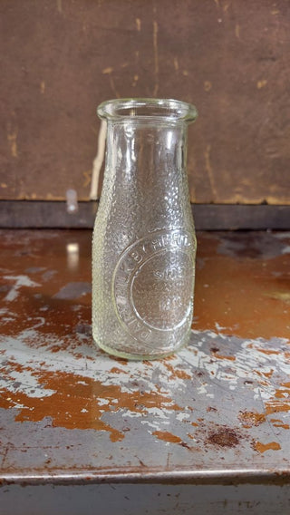 "Dairy Milk by Heritage Company - Since 1810" half pint pebble textured milk bottle