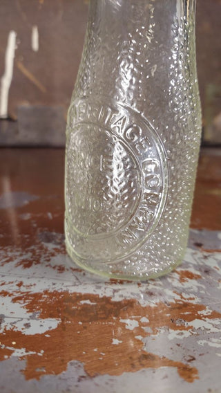 "Dairy Milk by Heritage Company - Since 1810" half pint pebble textured milk bottle