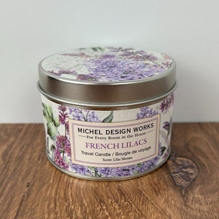 A tin container of Michel Design Works French Lilacs candle with a floral design on the lid.
