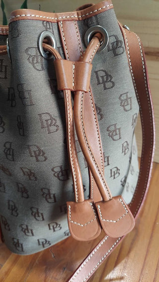 1990s Drawstring Shoulder Leather and canvas Bag by Dooney and Bourke (T&M) FIRM. (Wire Cutters in 888 folder)
