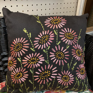 Black pillow with hand embroidered pink flowers