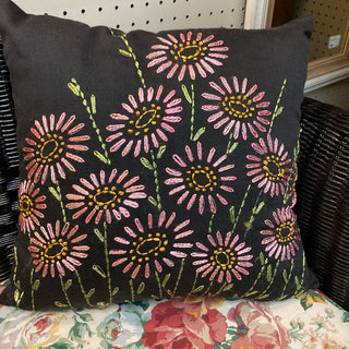 Black pillow with hand embroidered pink flowers