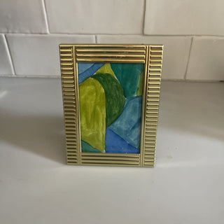 brass ribbed frame with abstract watercolor art