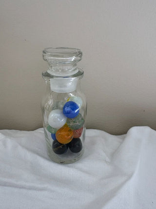 small glass jar with marbles