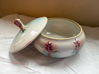pink and green round ceramic dish with lid