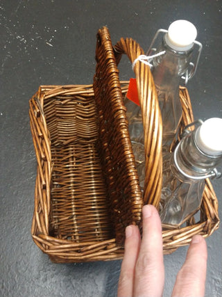 Small wicker picnic basket with bottles