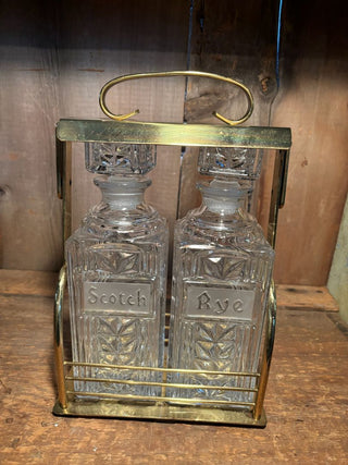 Set of Two (2) Cut Glass Scotch and Rye Decanters with Stoppers in Brass Locker