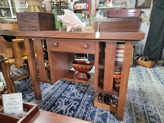 Wooden table with drawers and shelves in a store setting