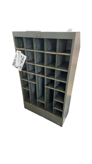 1949 pigeon hole cabinet by Neumade, with adjustable rack cubbie storage on locking casters. Vintage Midcentury film industry industrial rustic display.