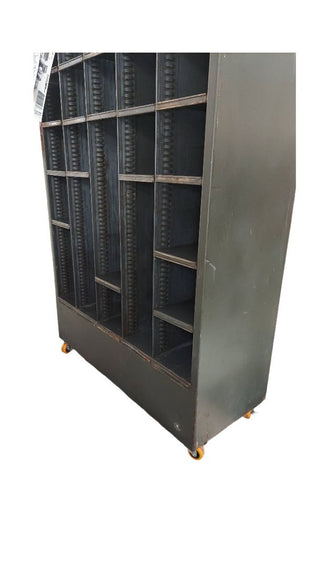 1949 pigeon hole cabinet by Neumade, with adjustable rack cubbie storage on locking casters. Vintage Midcentury film industry industrial rustic display.