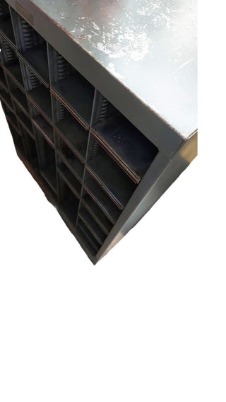 1949 pigeon hole cabinet by Neumade, with adjustable rack cubbie storage on locking casters. Vintage Midcentury film industry industrial rustic display.