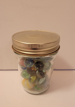 Jar of vintage marbles (gold top)