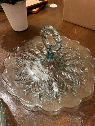 Clear glass dish with lid on a wooden surface