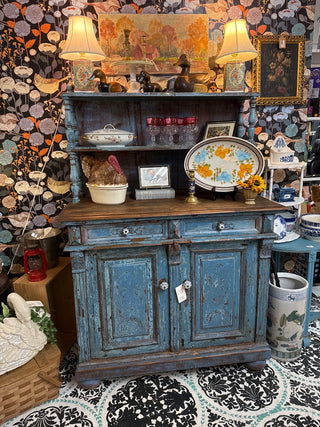 distressed blue antique sideboard with a wooden top and hutch.