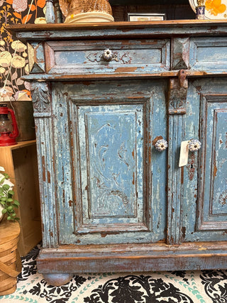 distressed blue antique sideboard with a wooden top and hutch.