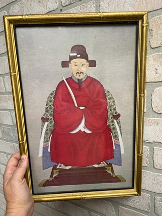 Sitting Asian man, framed glass