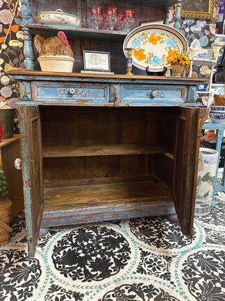 distressed blue antique sideboard with a wooden top and hutch.