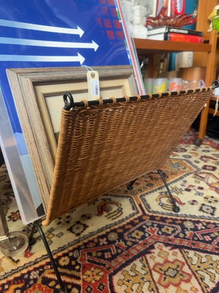 Vintage, wicker and black metal magazine rack