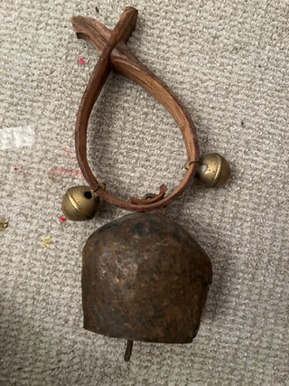 Rustic cowbell on band with two other bells