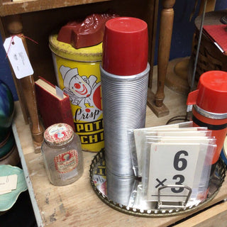 Silver thermos w/red lid