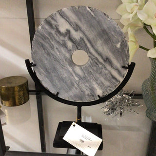 Gray Stone disk on black stand