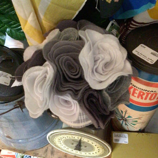 Gray felt flowers in a basket, artisan craft.