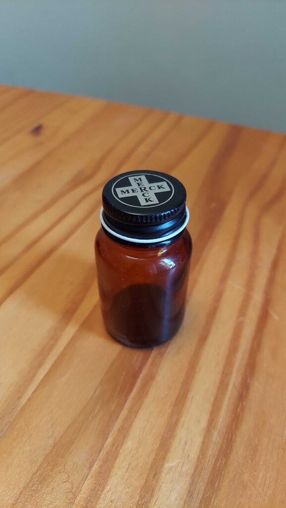 merck amber pharmaceutical bottle by Wheaton glass co, original metal MERCK screw cap